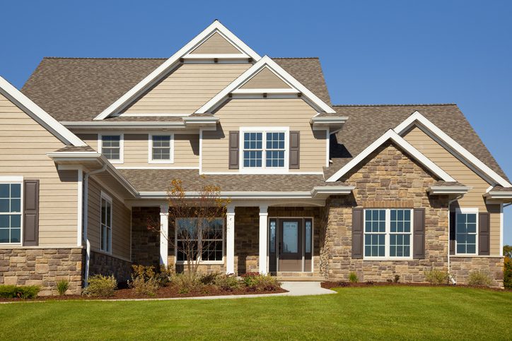 Stone and tan vinyl house with cedar accents